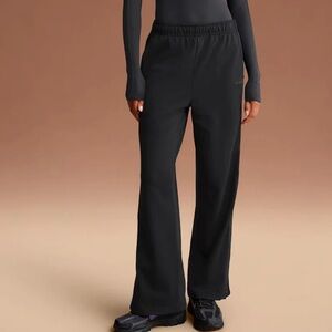 NikeSkims black matte tricot side snap pants in obsidian